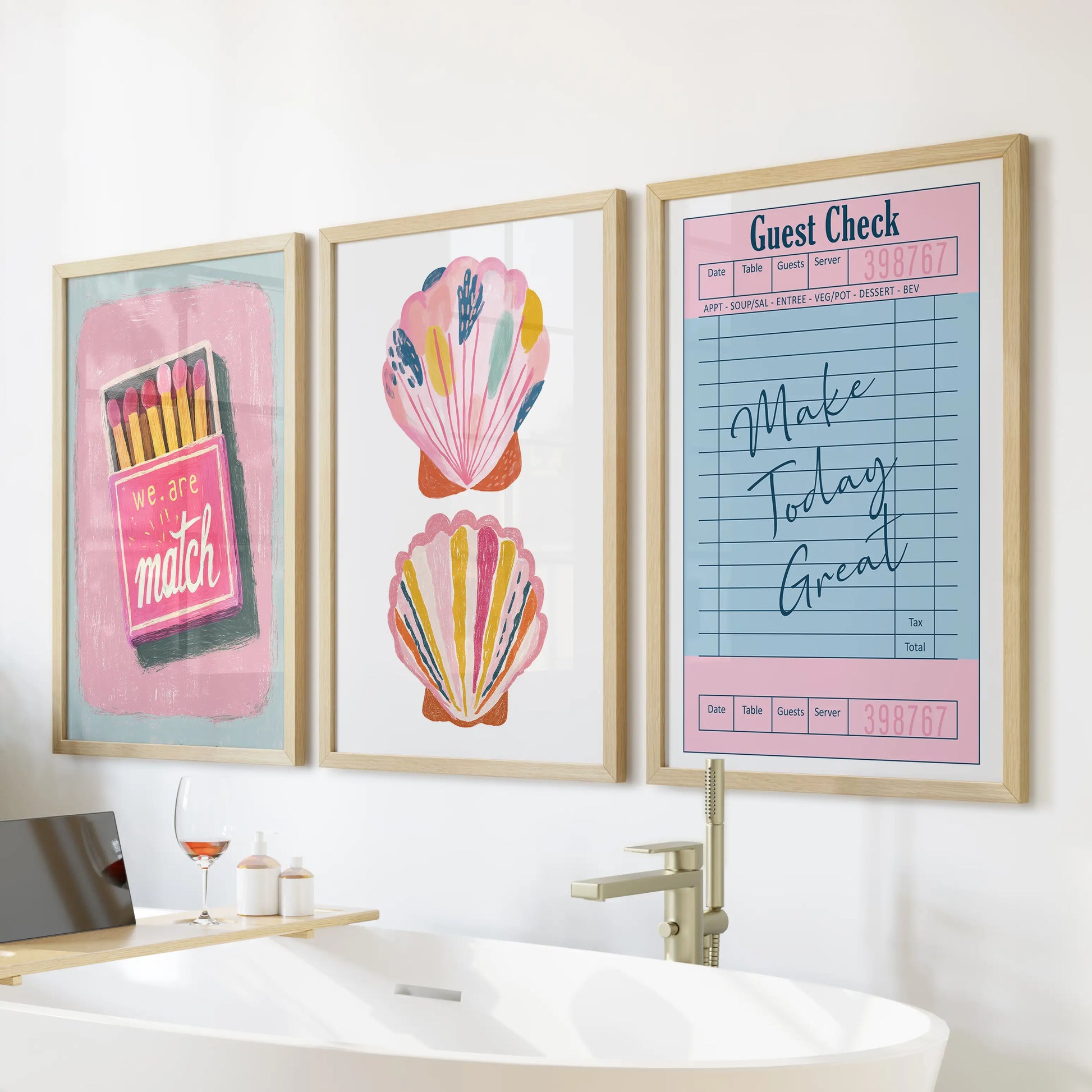 Large oak-framed wall prints, a set of three with a coastal Breeze, sit above the bathtub adding warm, sunlit calm to the bathroom.