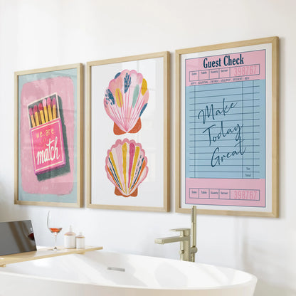 Large oak-framed wall prints, a set of three with a coastal Breeze, sit above the bathtub adding warm, sunlit calm to the bathroom.