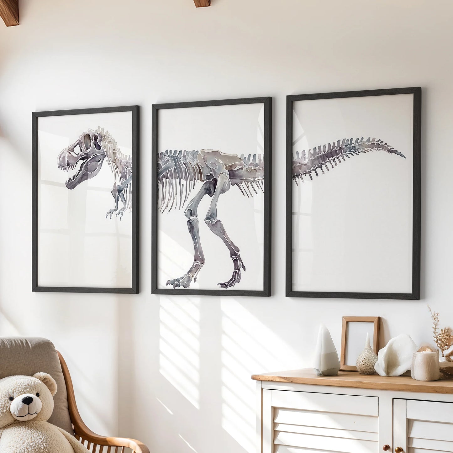 T. rex skeleton prints, 3-piece set, hang over a chest of drawers in black frames to anchor a children's room with playful prehistoric charm.