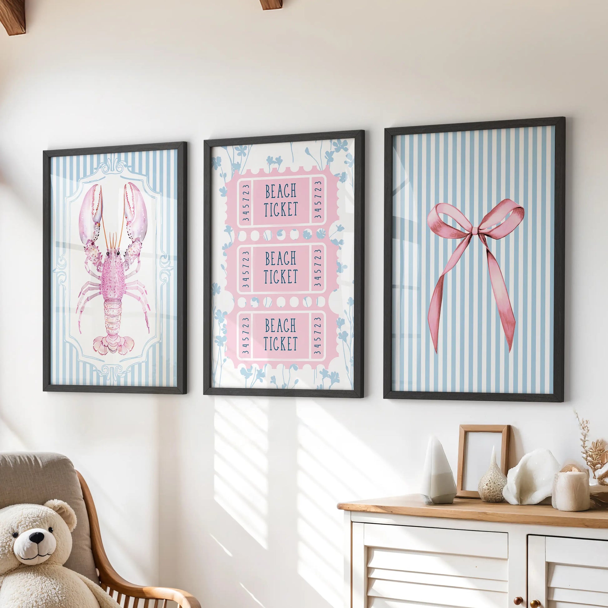Pastel coastal beach scenes set of three prints in black frames bring breezy wall art over the dresser in a cheerful children’s room.