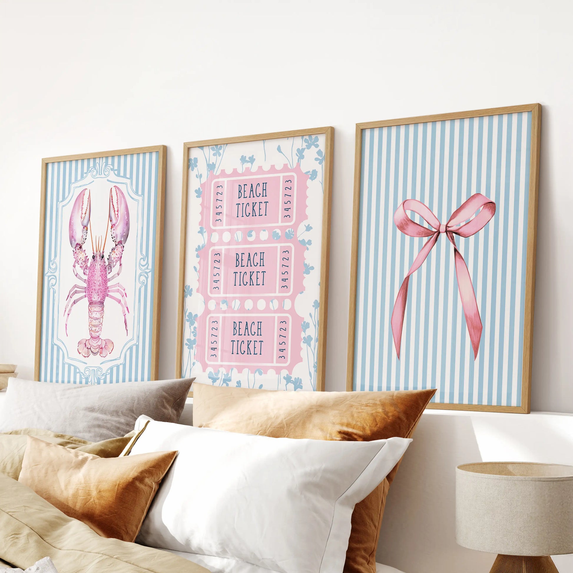 A trio of coquette bow prints in smooth wood frames sits neatly over the headboard, sweetening the light blue bedroom vibe.