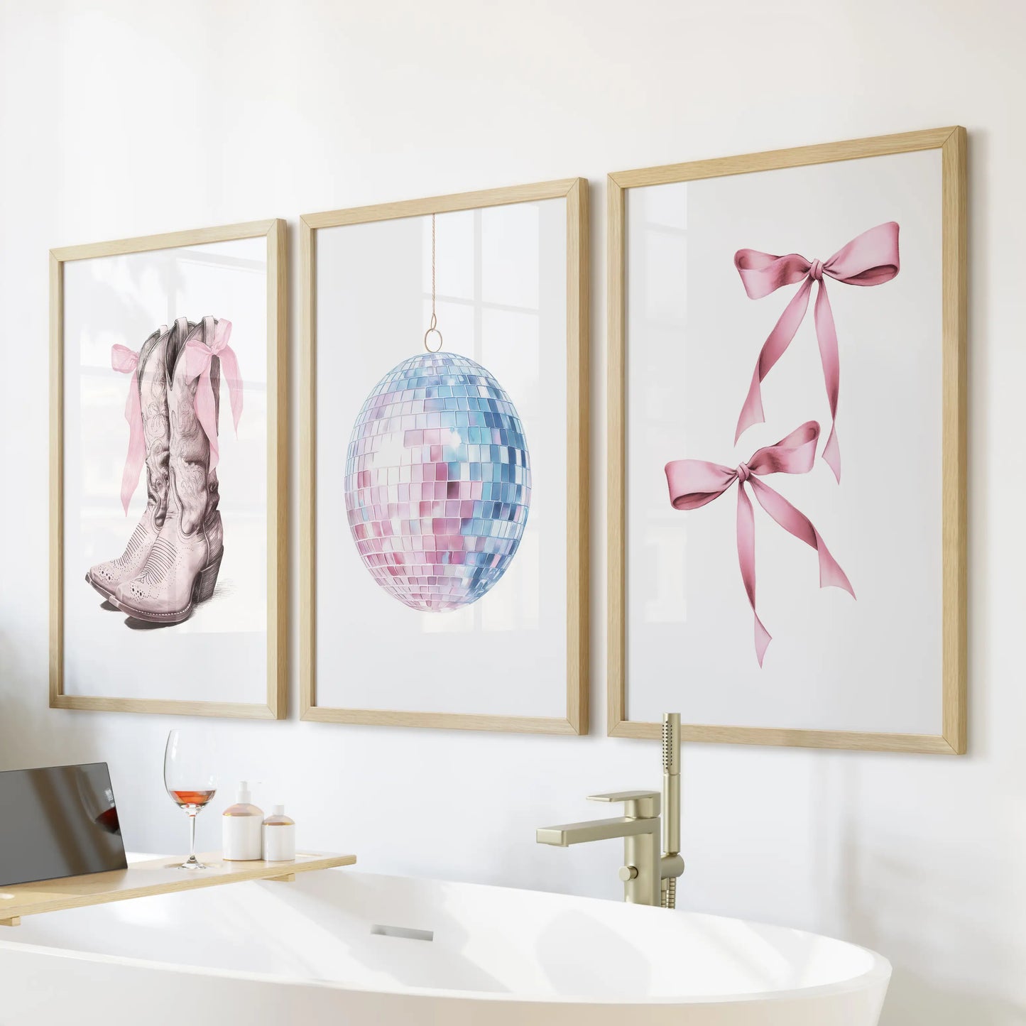 Preppy cowgirl wall art set of three, oak-framed and styled above the tub, gives the bathroom a chic coastal twist in soft pink and powder blue.