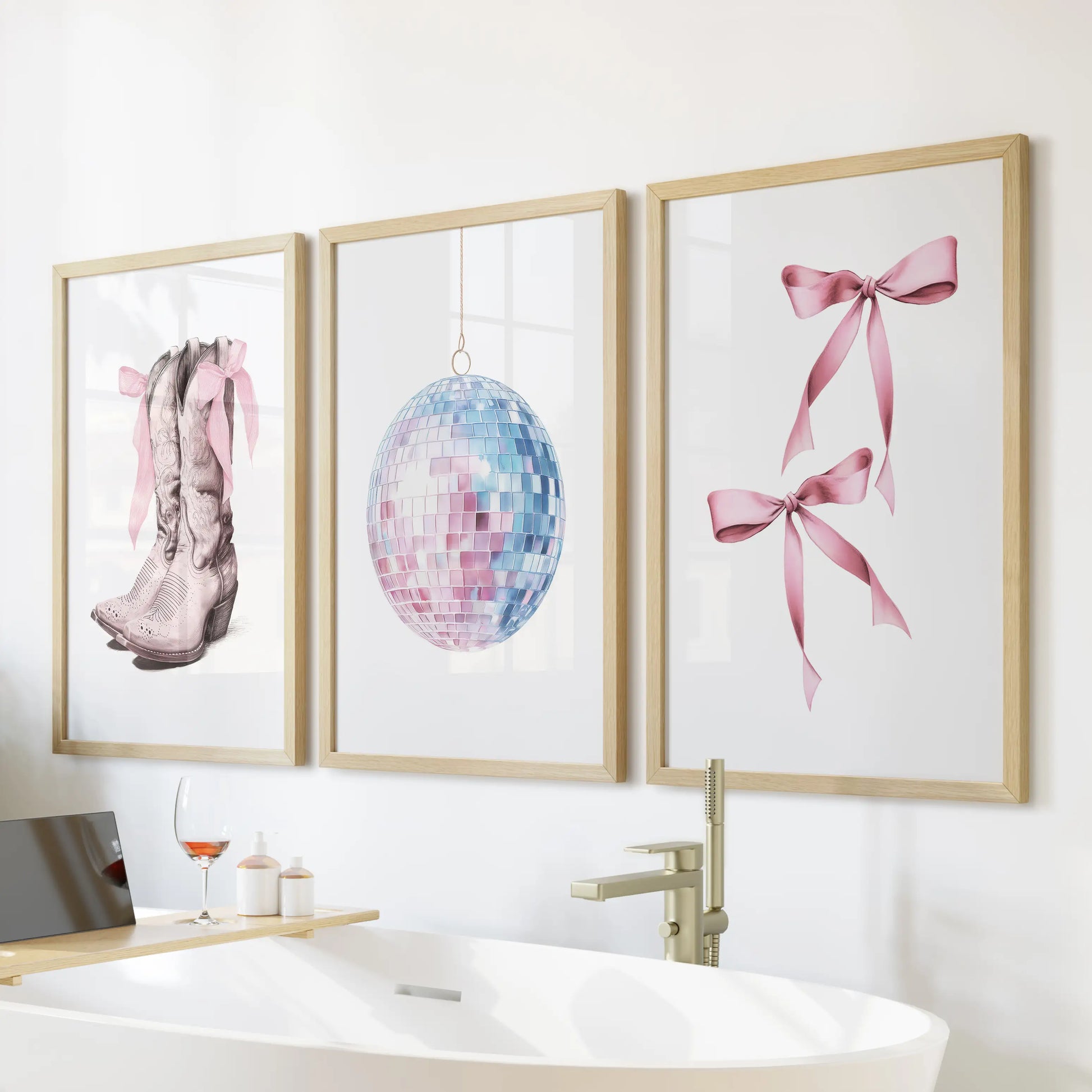 Preppy cowgirl wall art set of three, oak-framed and styled above the tub, gives the bathroom a chic coastal twist in soft pink and powder blue.