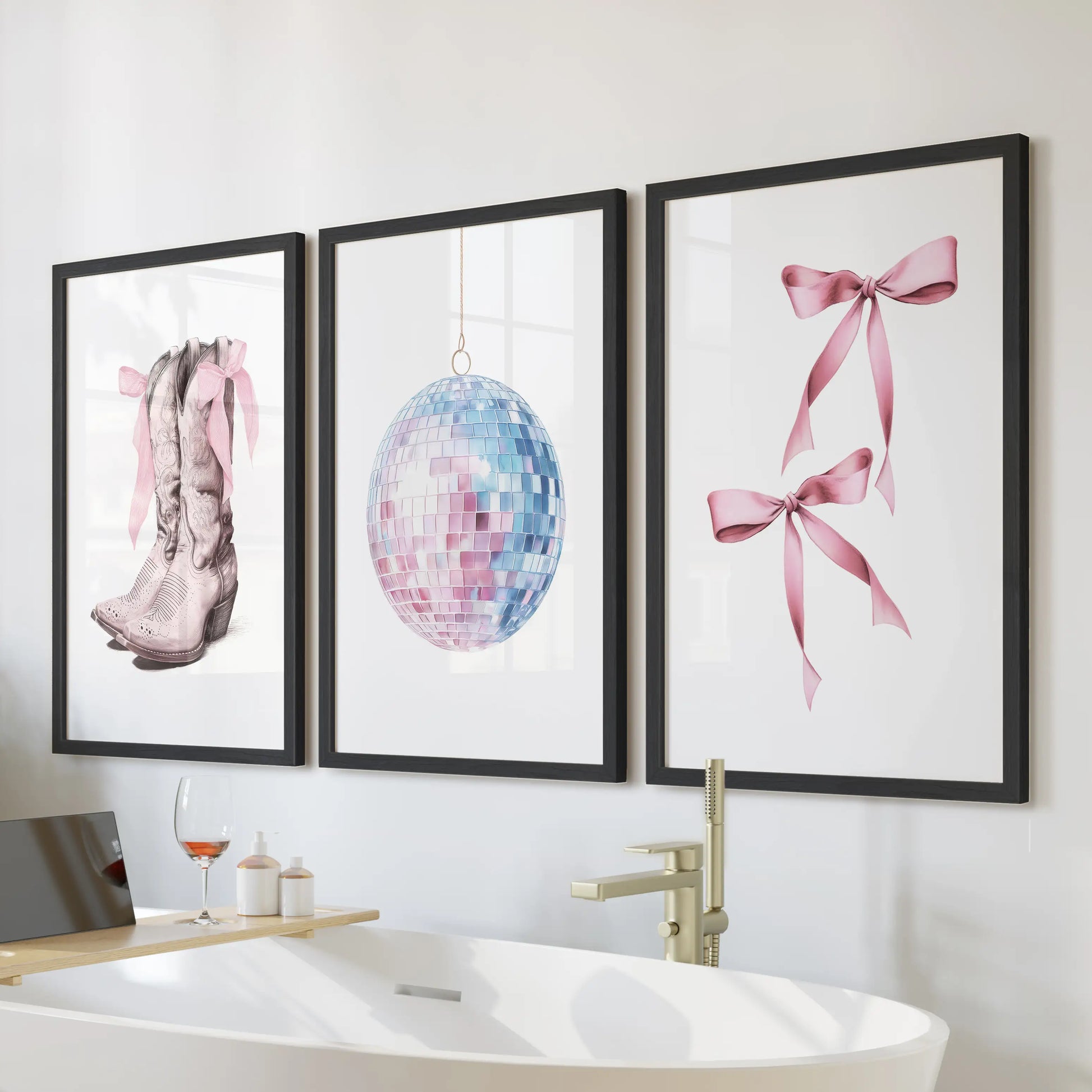 A black-framed trio of coastal cowgirl wall prints, in soft pink and blue, brightens the bathroom wall above the tub with a crisp preppy mood.