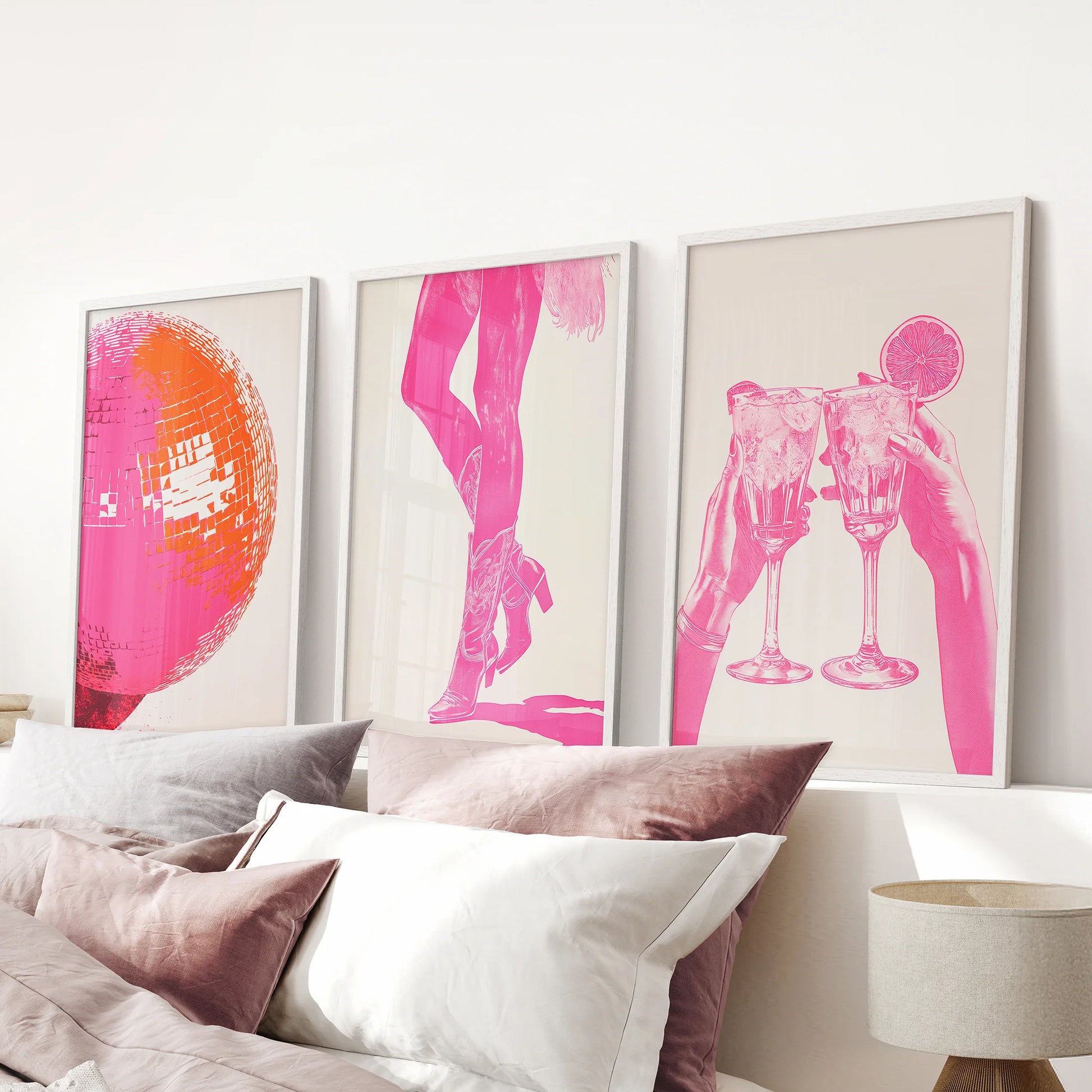 Funky preppy pink posters, a white-framed bundle of three, gather above the headboard to style a bright and girly bedroom focus.