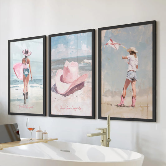 Coastal cowgirl surfer three-piece wall decor set of black-framed prints, hung above the tub to bring pink, beachy art to a clean, modern bathroom.