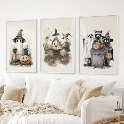 Festive fall wall art prints with pumpkins, animals, and cozy Halloween style. White frames above the sofa.