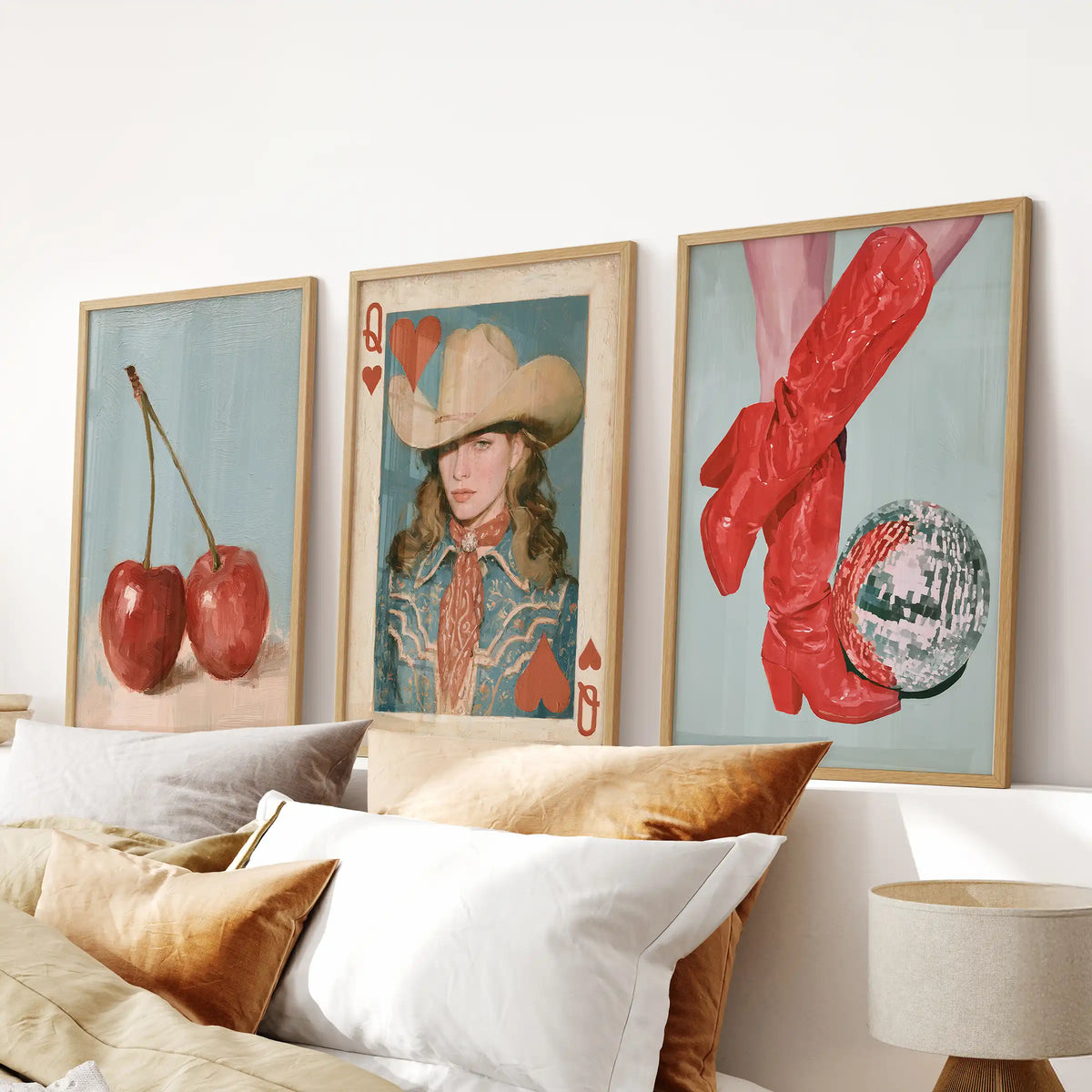 A three-piece red cowboy boots picture set in solid oak frames stands over the bed, striking a bold, girly-western note in the bedroom.