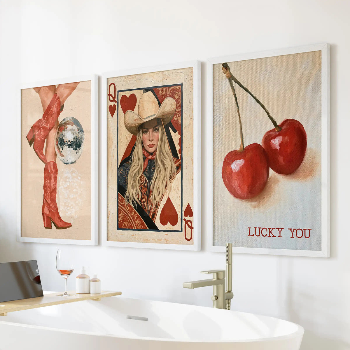 Vintage playing cards wall decor set of three in crisp white frames hangs above the bathtub wall, lending cheeky Western glam to the bathroom.