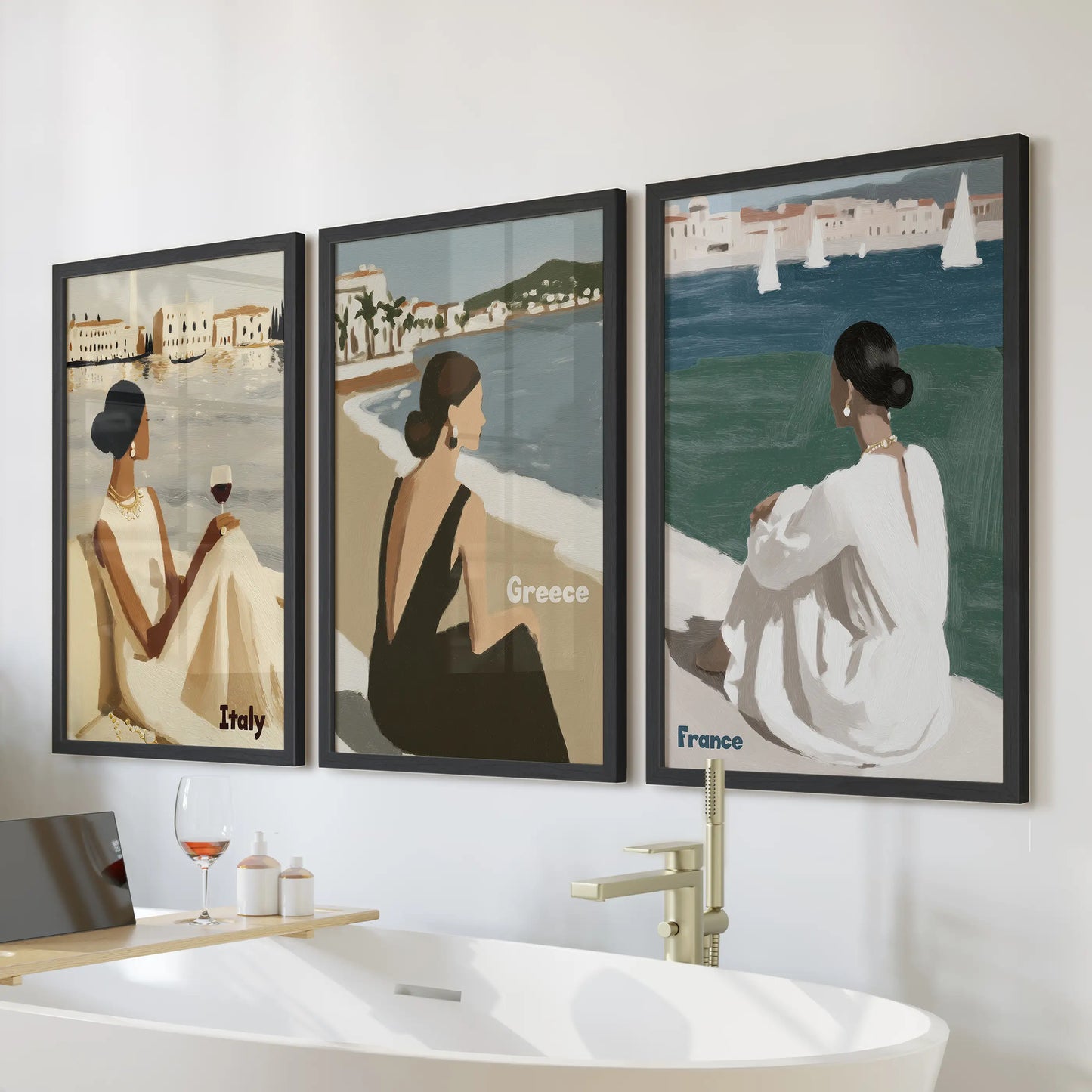 This three-piece wall art set in black frames hangs above the bathtub, bringing relaxed Mediterranean breezes to a light, spa-style bathroom.