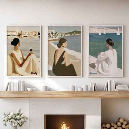 A trio of white-framed coastal wall prints lines the family-room mantle, bringing a breezy, sun-washed shoreline atmosphere indoors.