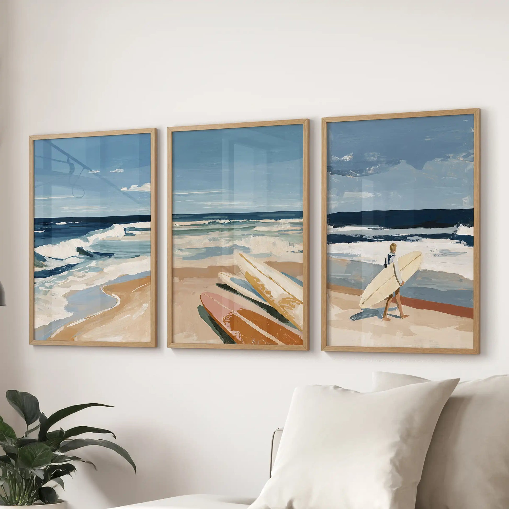 Surfer riding a wave wall art prints, a set of three in solid oak frames, float above the sectional to bring laid-back coastal rhythm to the living room.
