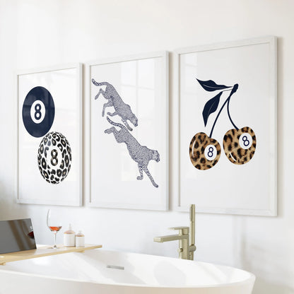 Cherry and eight-ball wall art, a 3-piece print set in clean white frames, adds a fun retro note to the bathroom above the bath.