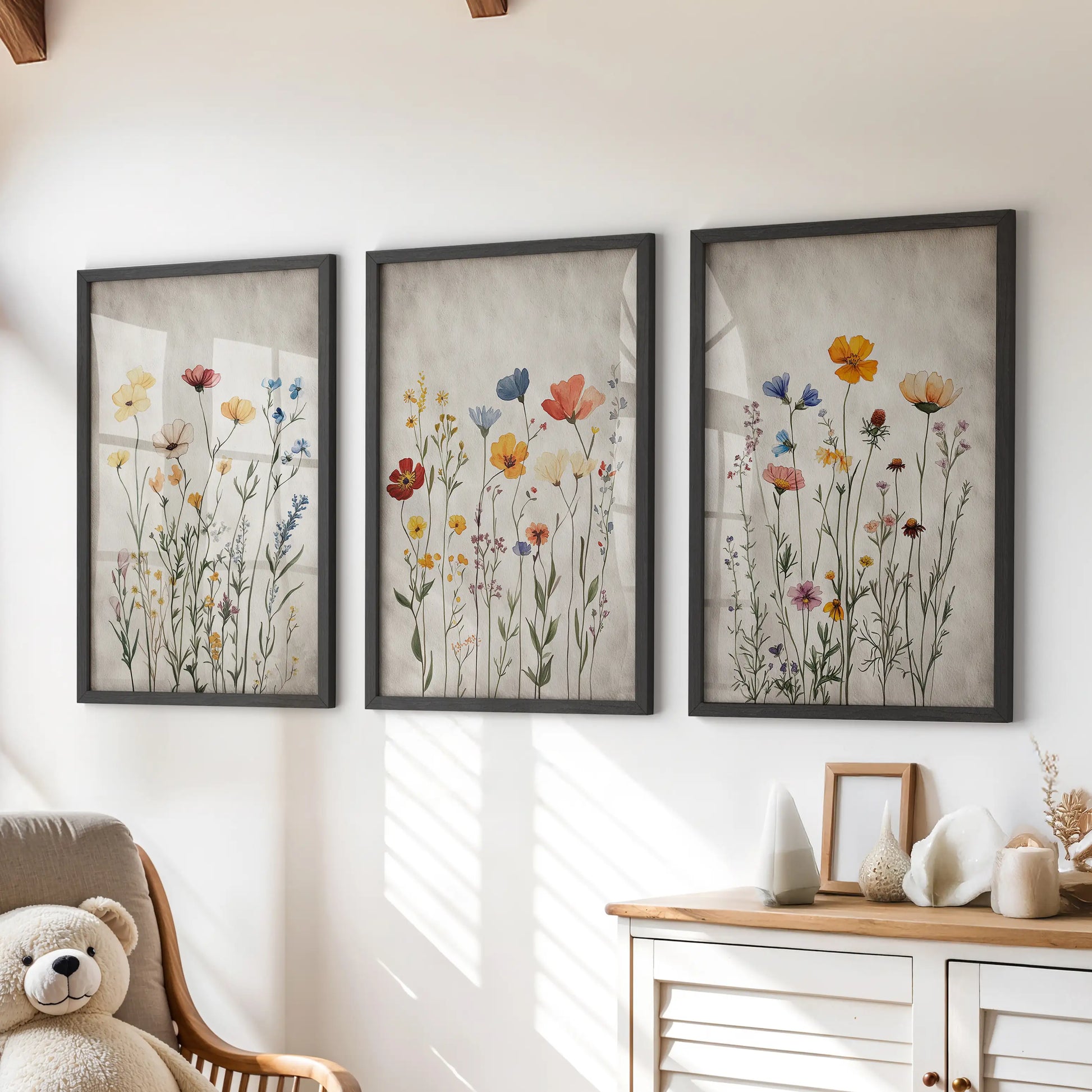 Boho floral prints, a three-print wall art set in black frames, styled to hang over the dresser in a cheerful kids playroom.