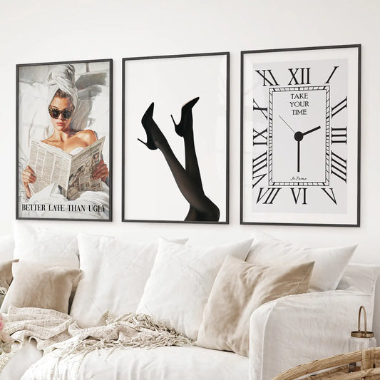 Black and white fashion wall art set of 3 with girl, heels, and clock. Glamour chic posters. Black frames over the couch.