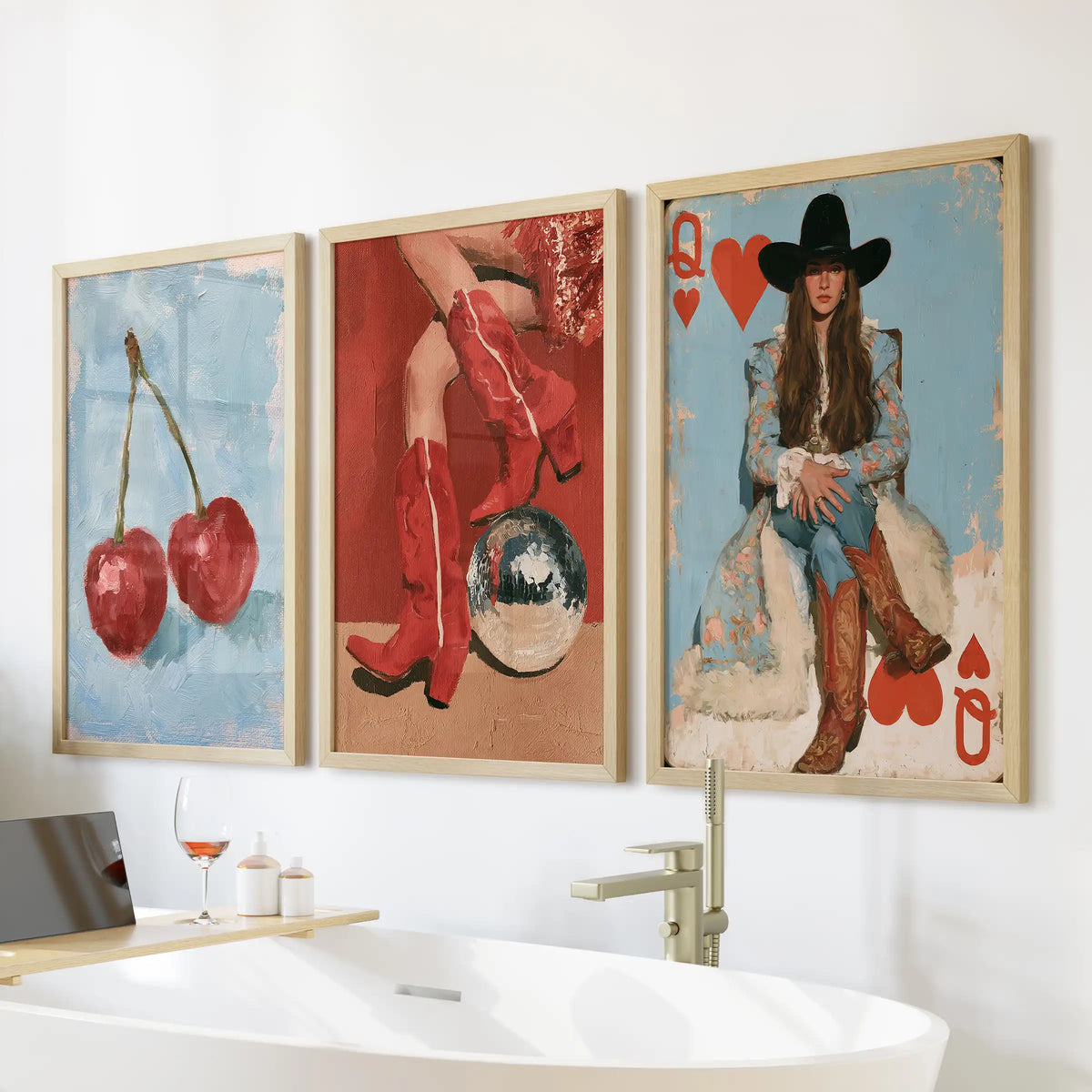 Three retro cowgirl wall art prints in warm wood frames hang above the tub, bringing sun-drenched Western vibes to the bathroom.