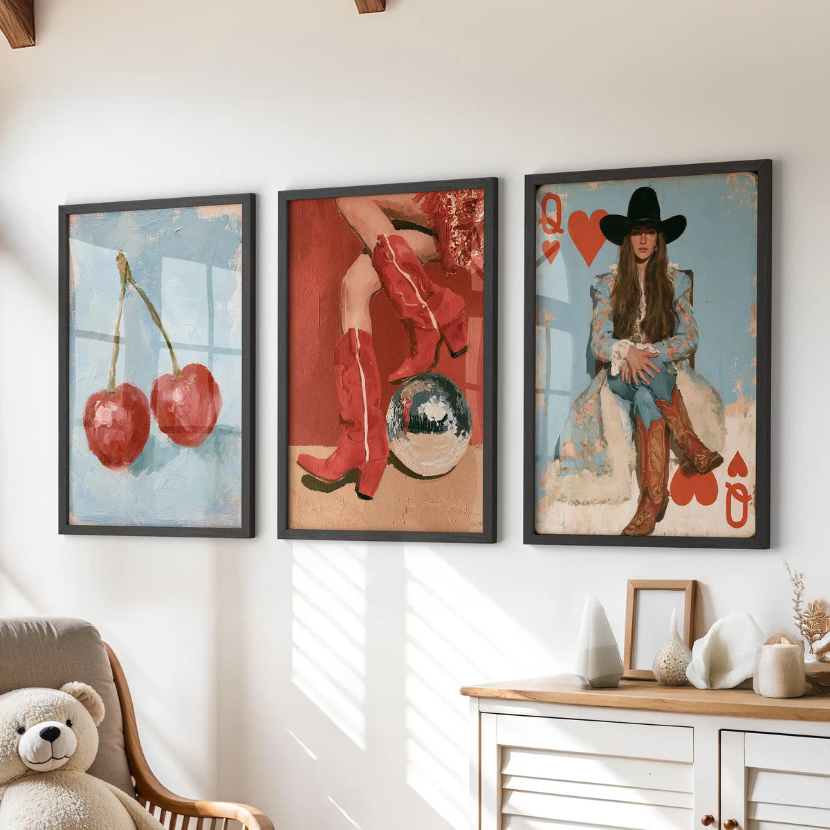 Three cherries art prints in sleek black frames sit over the chest of drawers, bringing a sweet touch to the lively playroom.