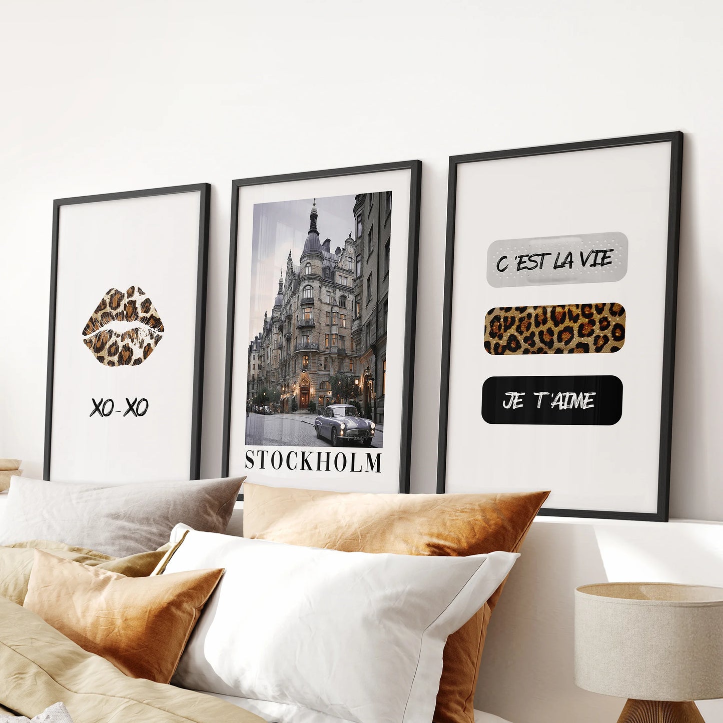 Fashion magazine cover prints, 3-piece set, create a chic wall display in the bedroom over the bed, presented in sleek black frames.