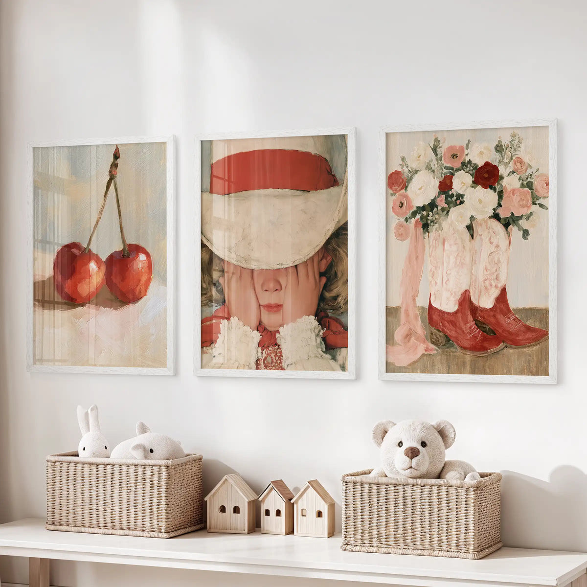 Three vintage girl illustration posters in white frames soften the children’s room, resting neatly over the toy storage bench.