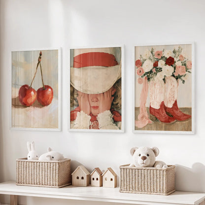 Three vintage girl illustration posters in white frames soften the children’s room, resting neatly over the toy storage bench.