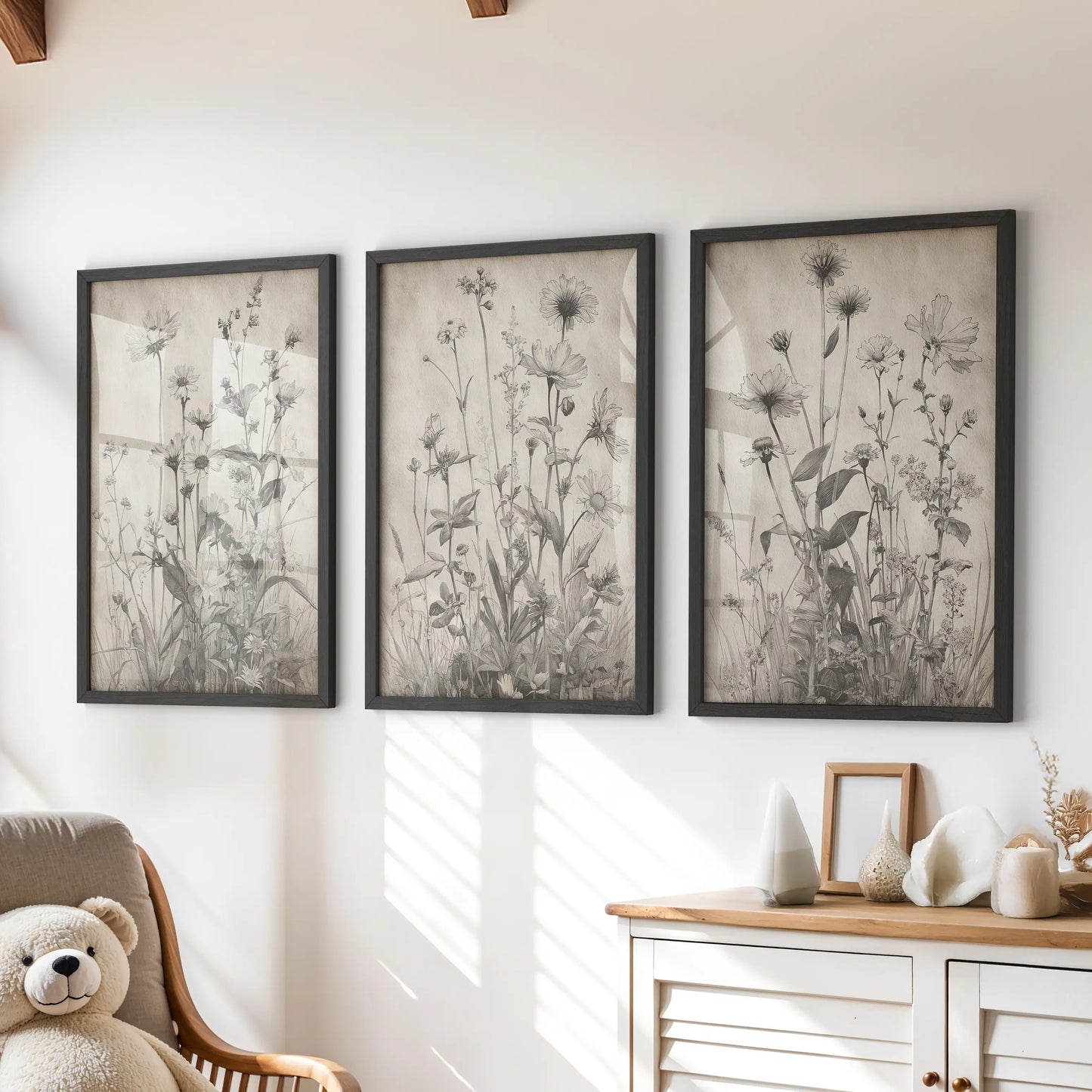 Vintage botanical prints, a three-piece wall art set in black frames, add soft, rustic character to a kids room over the chest of drawers.