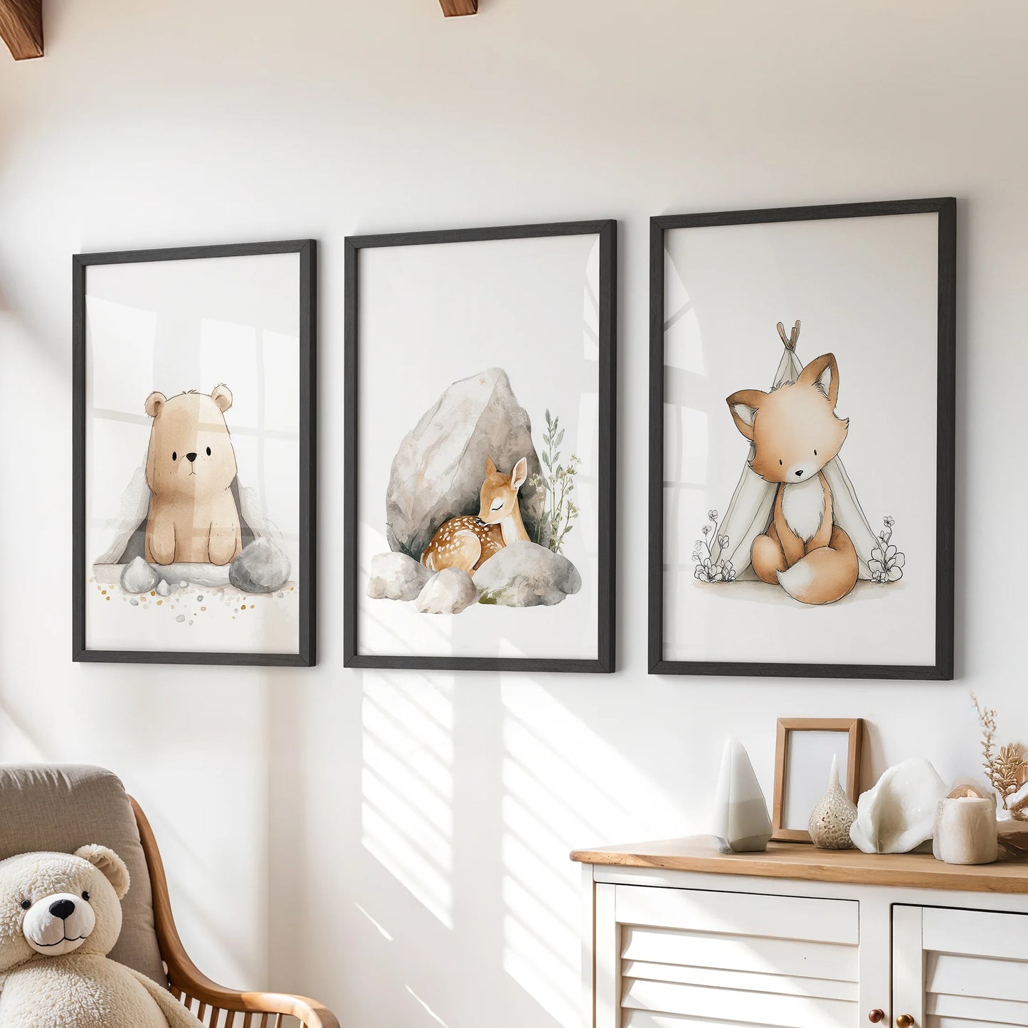 Playful woodland animal wall decor, a 3-piece set in sleek black frames, adds a cheerful touch over the dresser in a children's room.