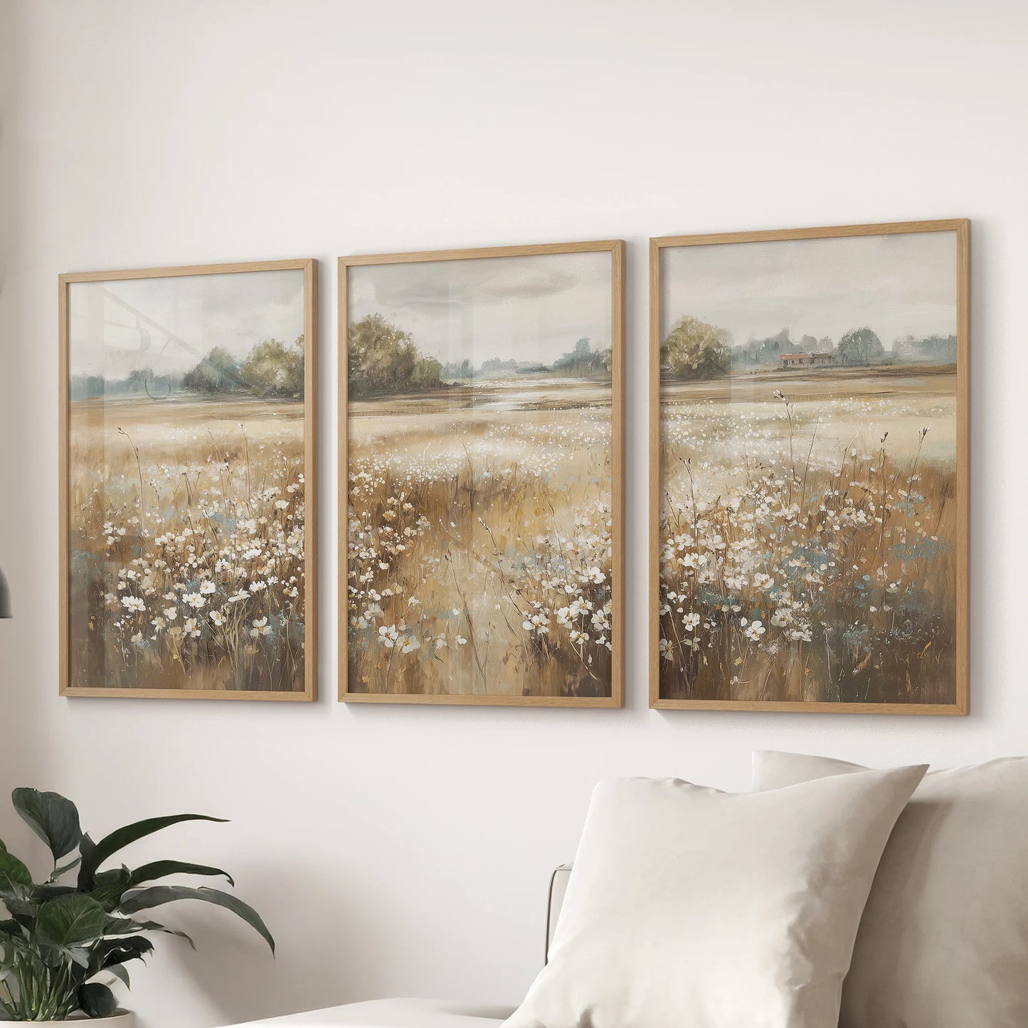Muted wildflower prints, a trio in natural wood frames, hang above the sectional in the sitting room for a quiet, pastoral accent that feels effortlessly collected.