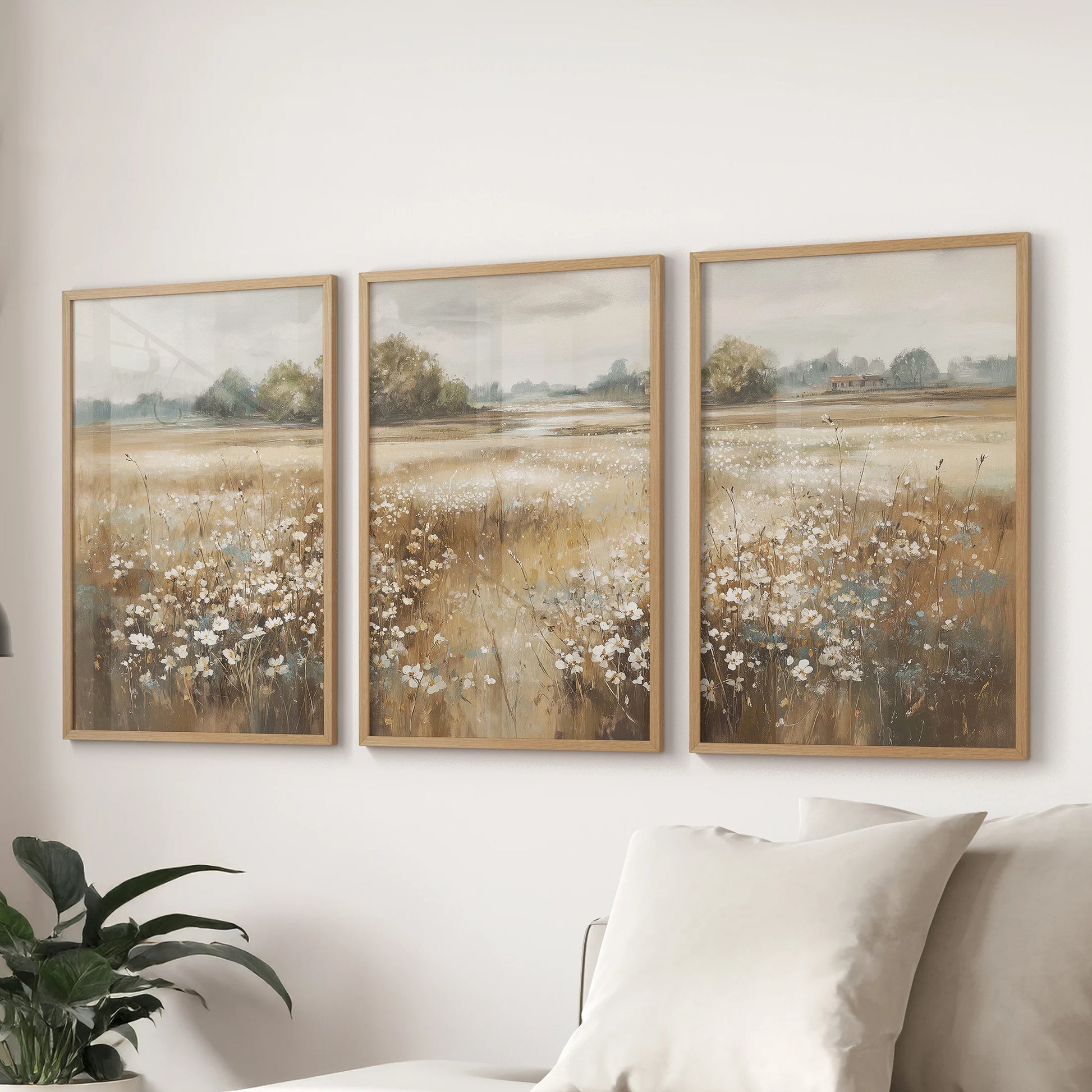 Muted wildflower prints, a trio in natural wood frames, hang above the sectional in the sitting room for a quiet, pastoral accent that feels effortlessly collected.