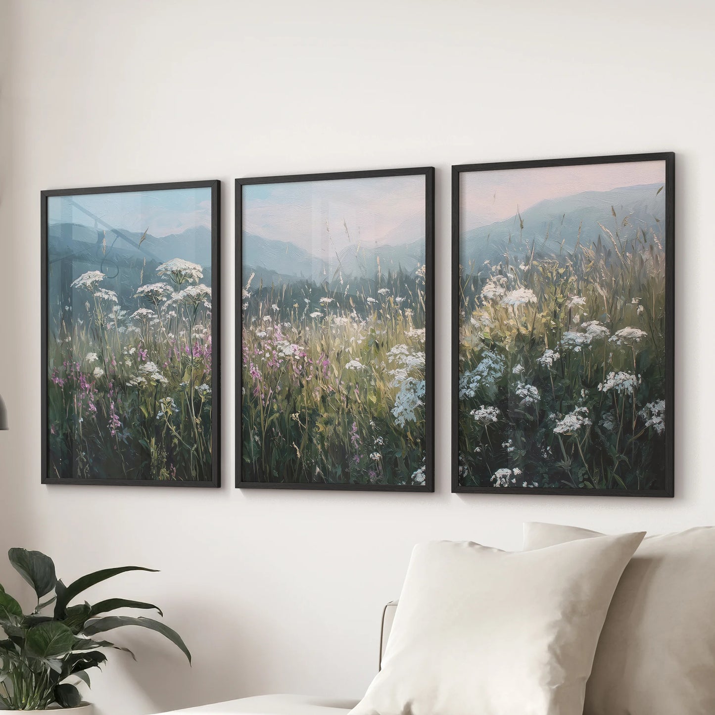 Neutral countryside fields print set of three, black framed wall art styled above a sectional sofa in the family room for a calm farmhouse look.