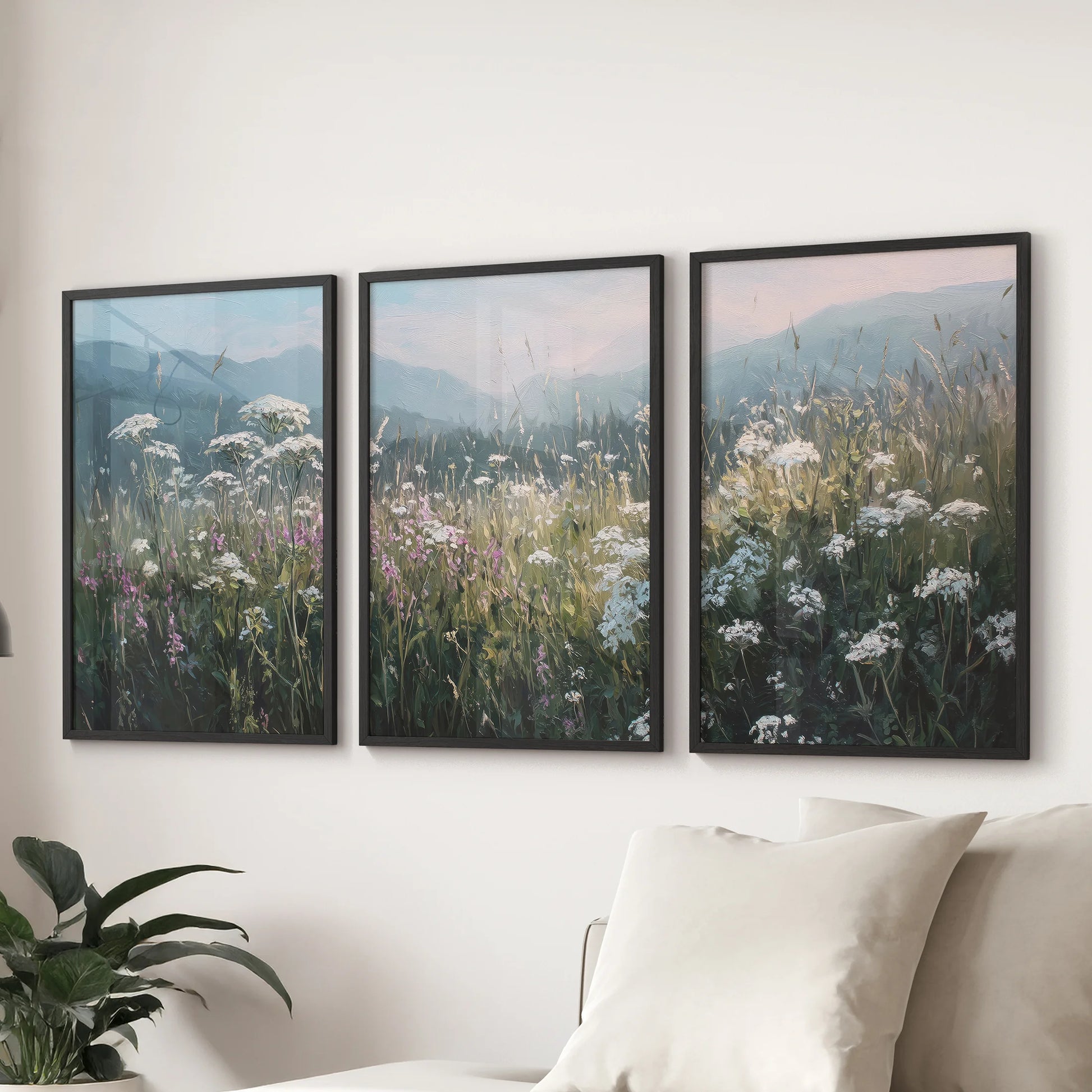 Neutral countryside fields print set of three, black framed wall art styled above a sectional sofa in the family room for a calm farmhouse look.