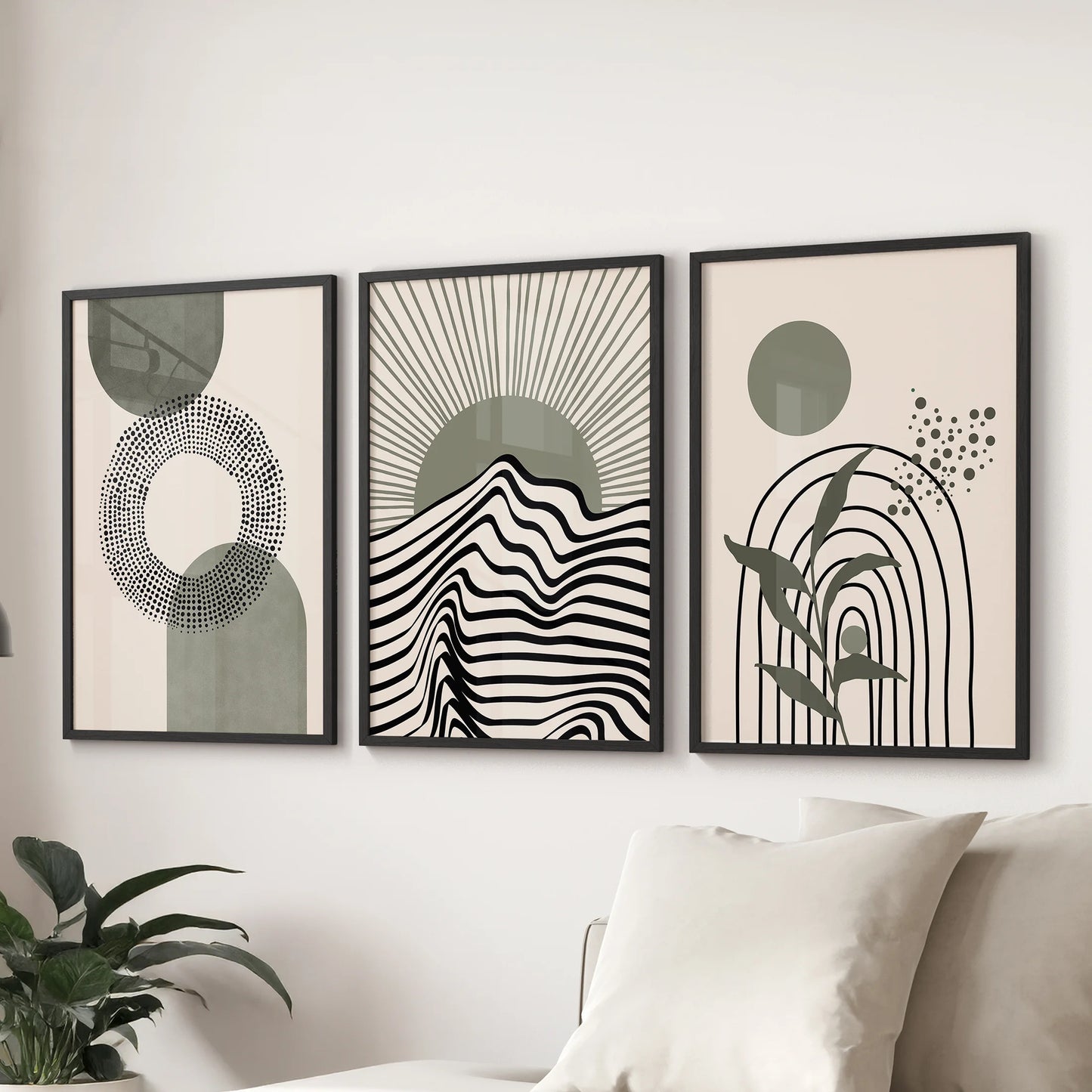 Set of three geometric wall posters in sage and neutrals lines the sitting room wall behind the couch, each in sleek black frames for a modern touch.
