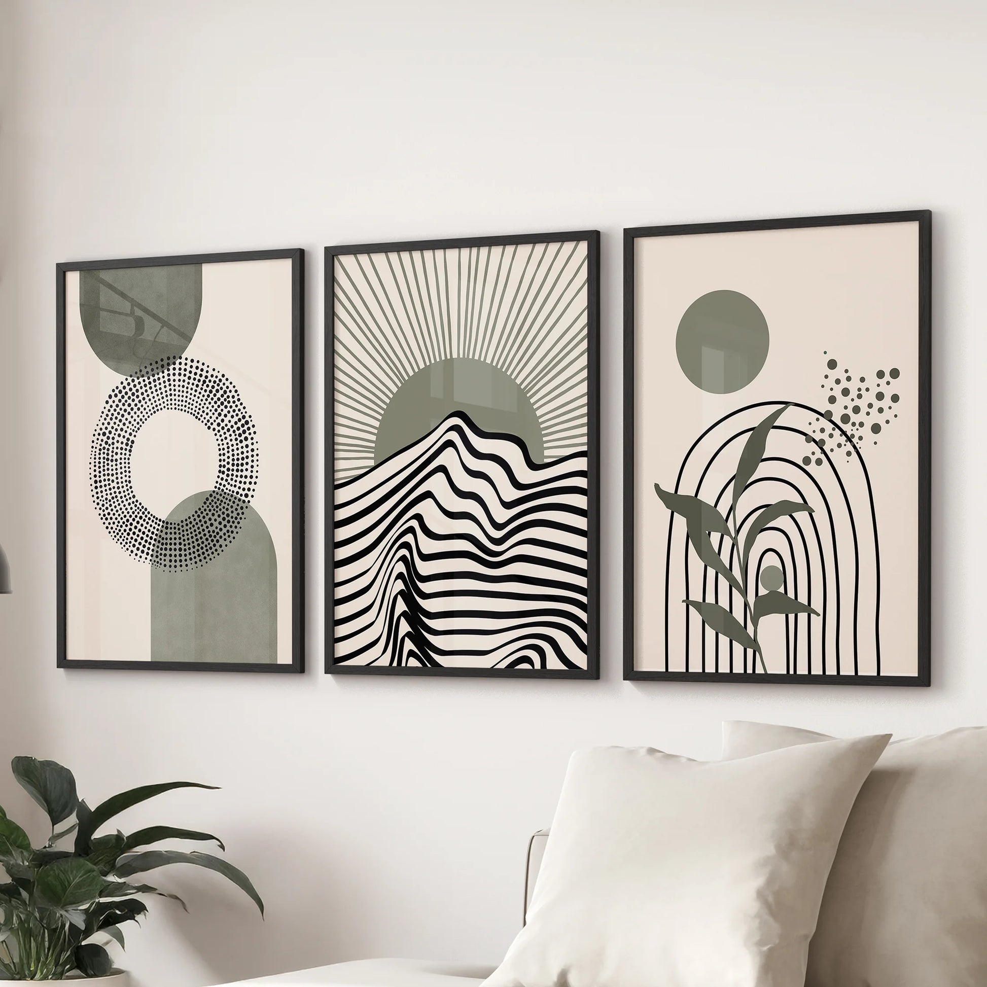 Set of three geometric wall posters in sage and neutrals lines the sitting room wall behind the couch, each in sleek black frames for a modern touch.
