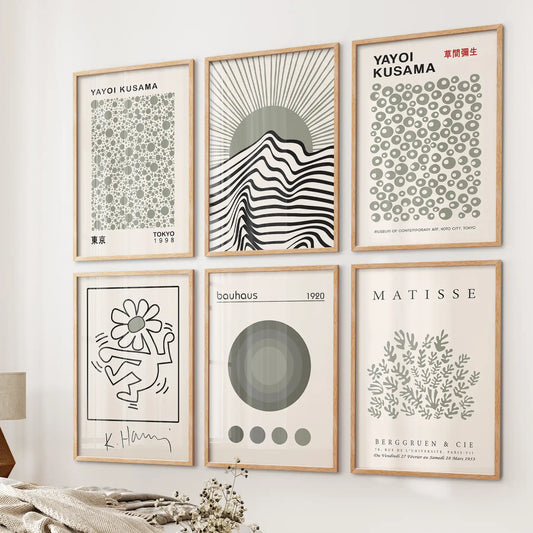 Sage green Matisse and Kusama prints in wood frames, 6-piece modern gallery wall above bed