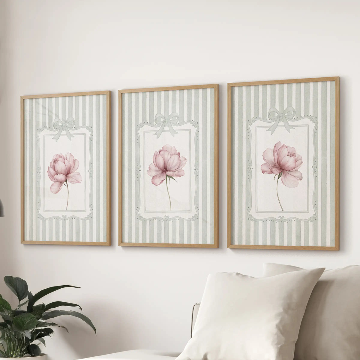 Three-piece French country floral wall art set in natural wood frames, featuring pink peonies on sage stripes over a living room sofa.