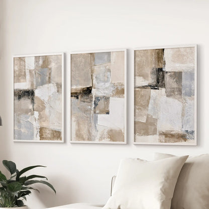 Geometric line forms, a three-piece wall art set, float above the couch in the sitting room within crisp white-framed prints.