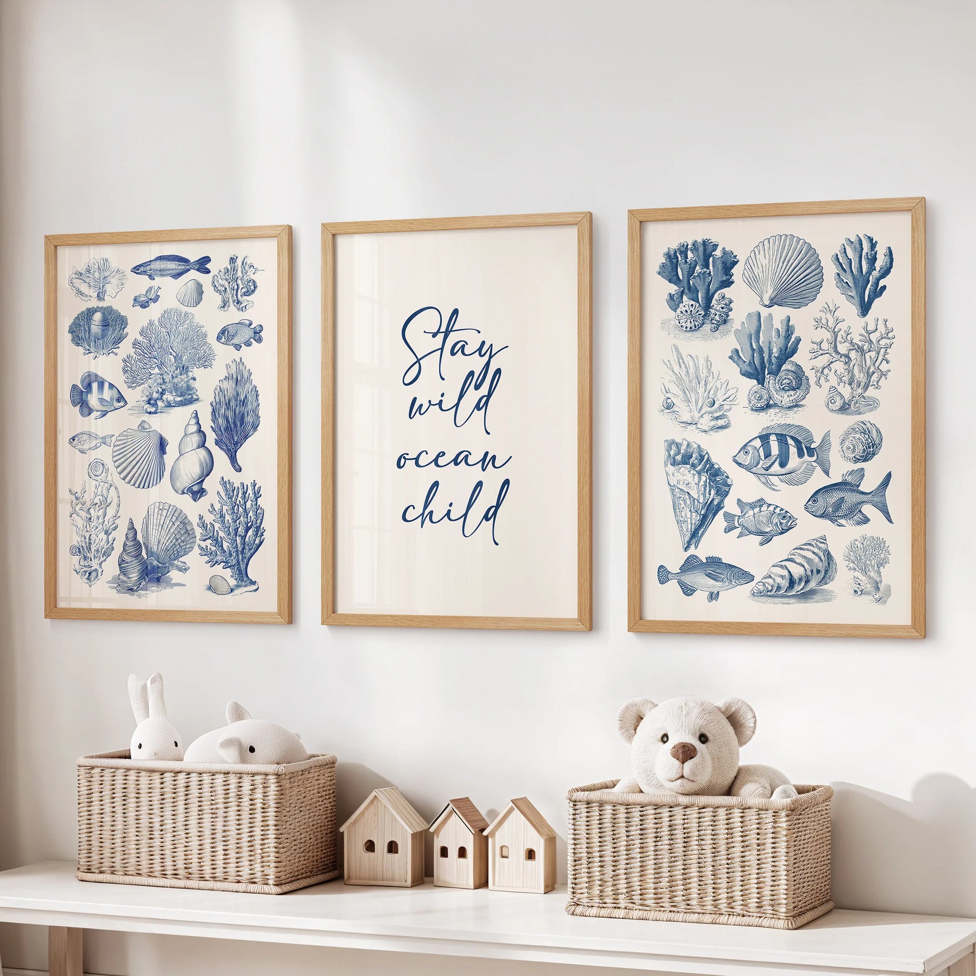 Thin wood-framed sea life illustration set of three large wall prints keeps a kids playroom neat and lively above toy storage.