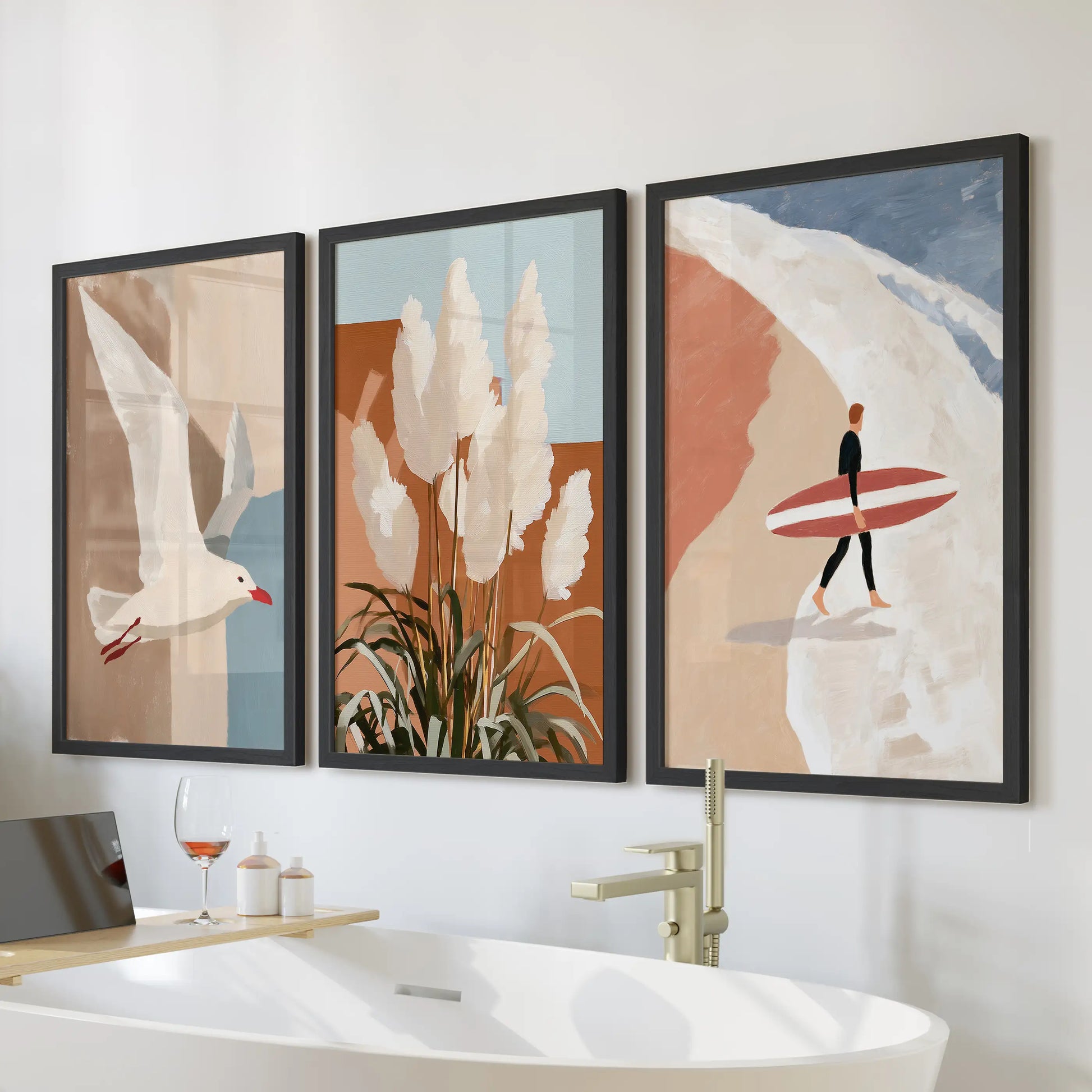 Seagull in flight, 3-piece wall art set in black frames, hangs over the bathtub to bring airy coastal calm to the bathroom with terracotta beach notes.