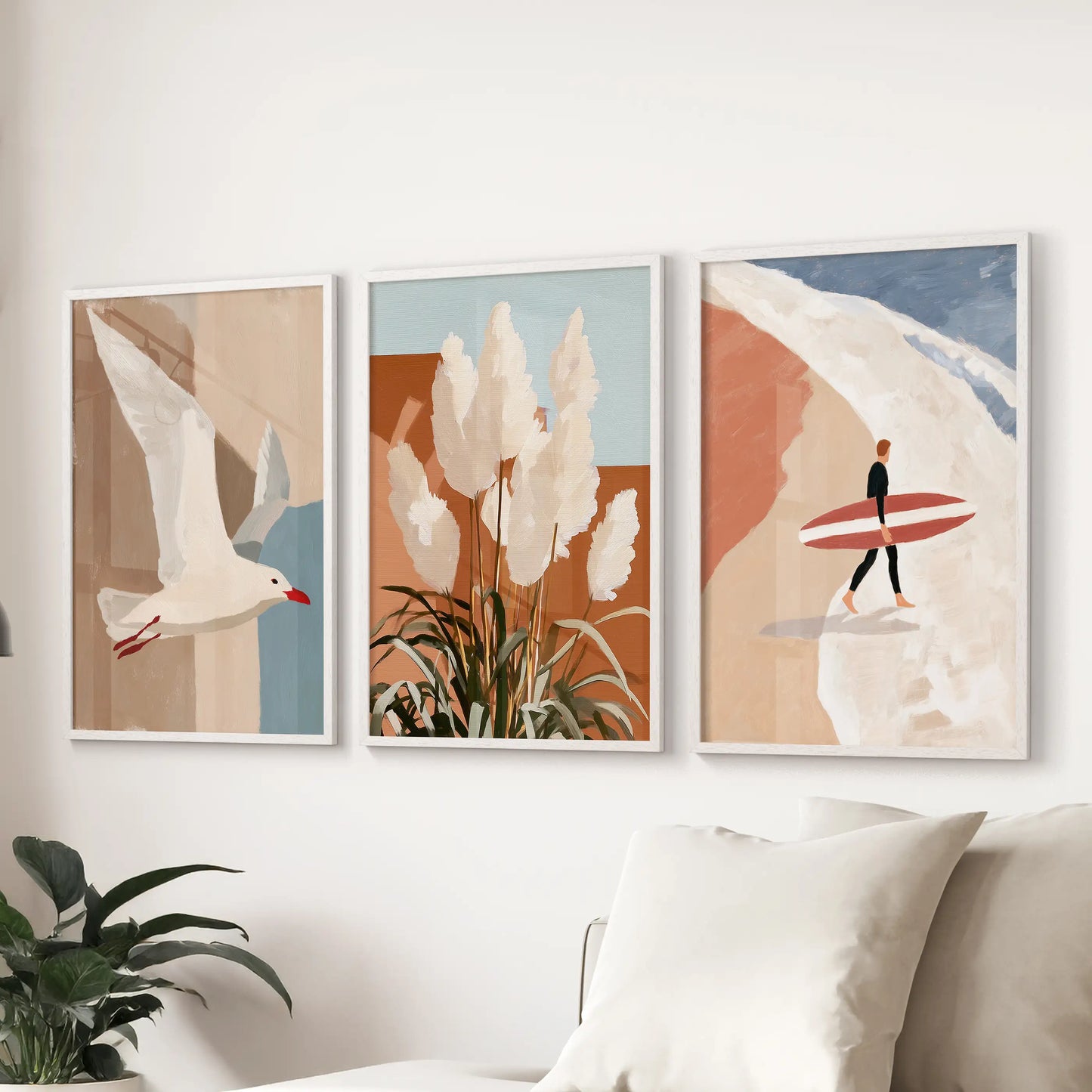 Three clean white-framed art prints of a seagull in flight float above the sectional, adding airy motion and seaside calm to the living room.