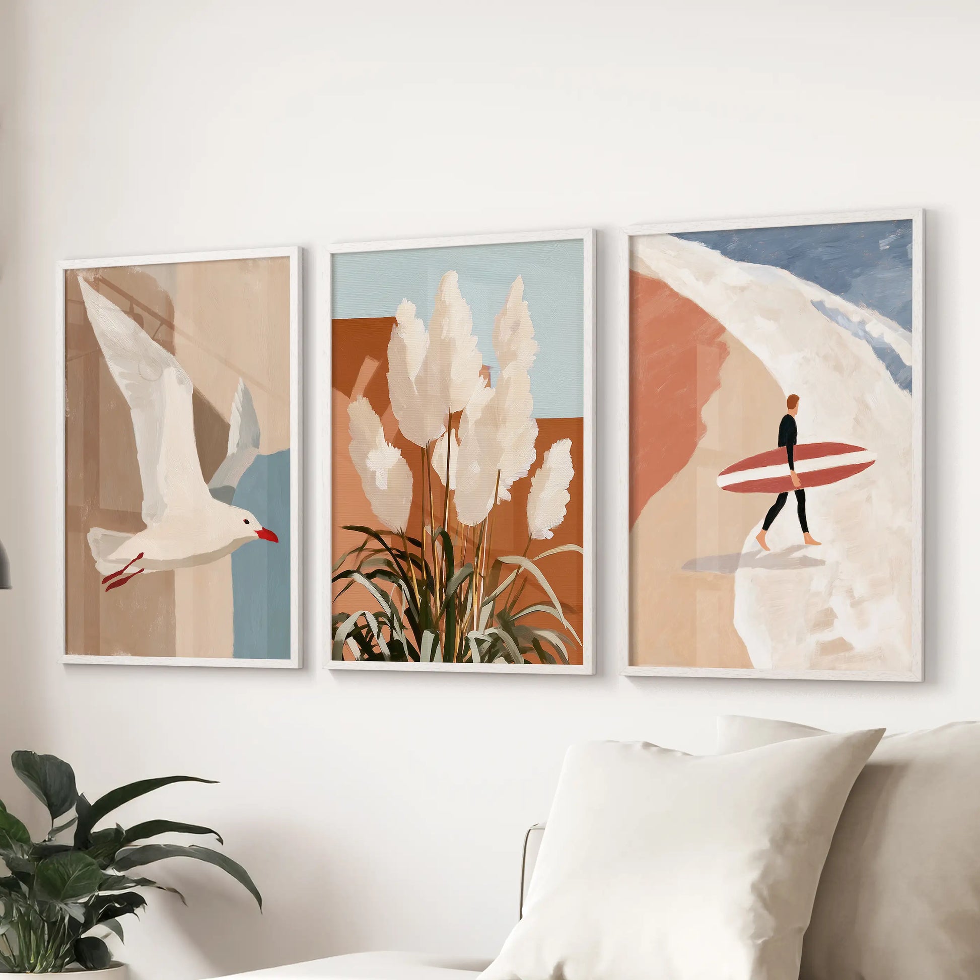 Three clean white-framed art prints of a seagull in flight float above the sectional, adding airy motion and seaside calm to the living room.
