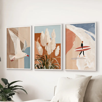 Three clean white-framed art prints of a seagull in flight float above the sectional, adding airy motion and seaside calm to the living room.