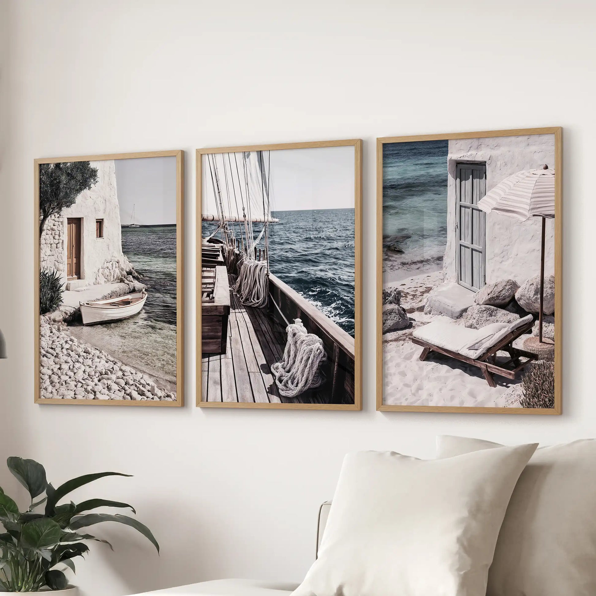 Luxury yachts poster set of 3 in oak frames, spanning the lounge wall behind the sofa for a polished, wind-at-sea finish.