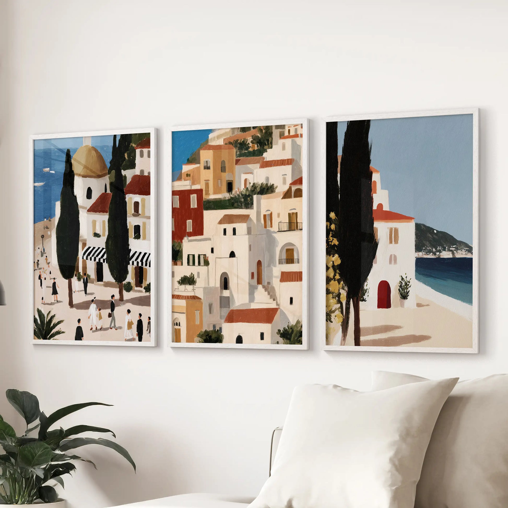 Spanish seaside village prints, 3-piece art set in white frames, arrange behind the couch to add bright facades and blue-water calm to the family room.