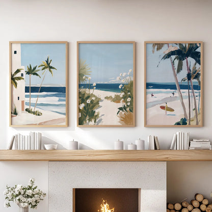 Set of three light-oak-framed seaside landscape prints centers above the living room fireplace, blending gentle beach colors and warmth.