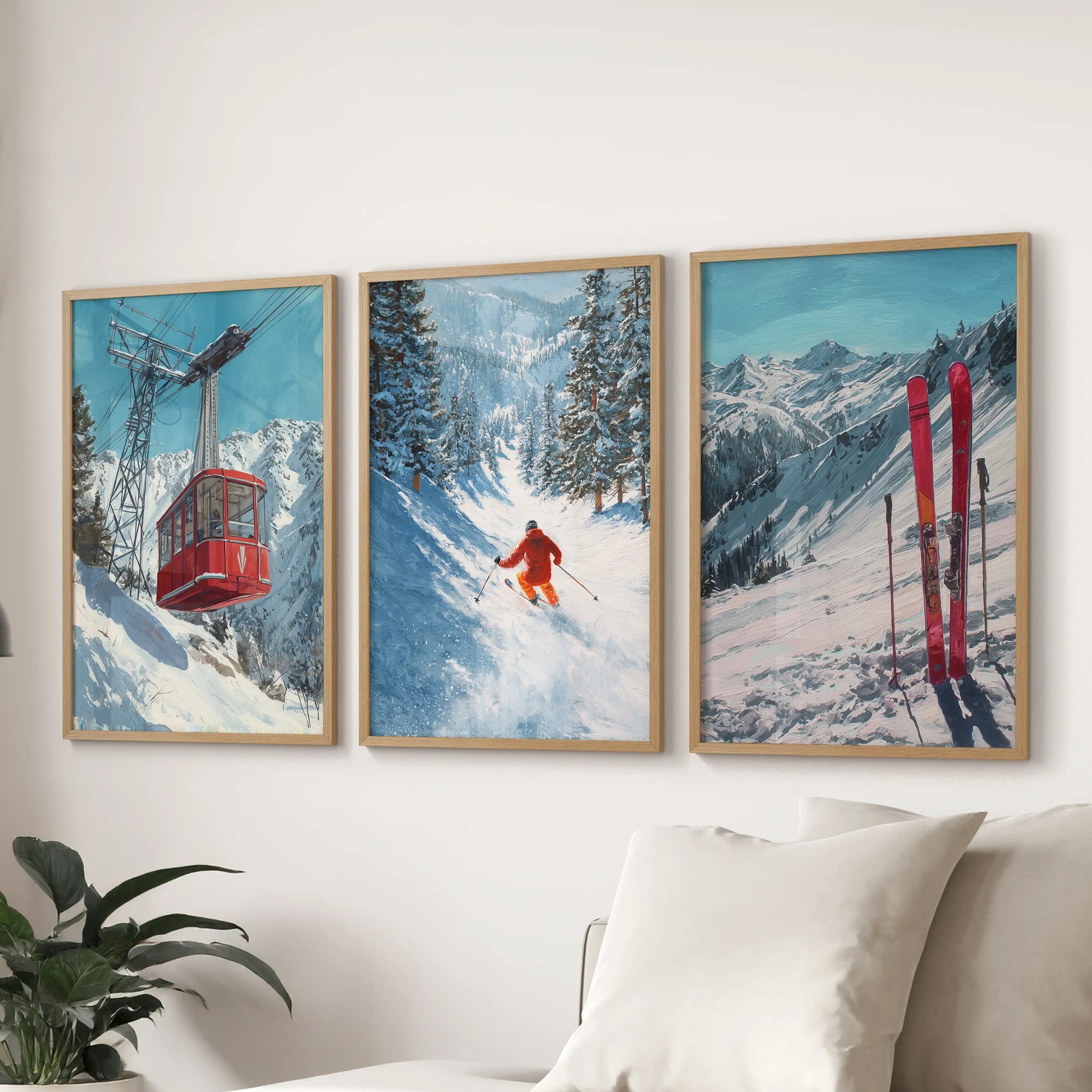 A light-wood framed set of three wall prints showing ski lift scenes, placed above the living-room couch with crisp, modern balance.