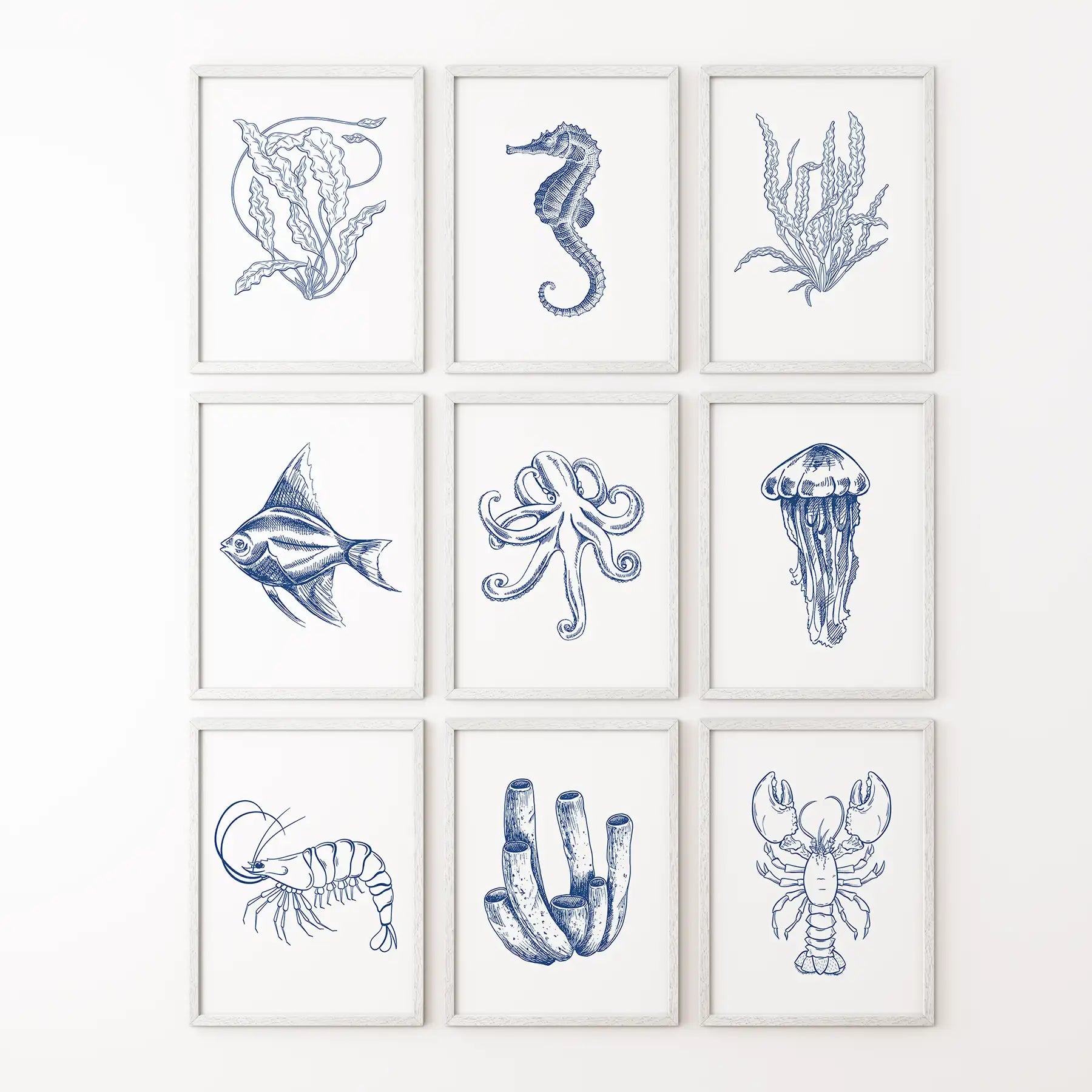 Coastal gallery wall set of 9 nautical art prints in ocean inspired blue tones. White frames for bathroom.

