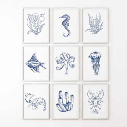 Coastal gallery wall set of 9 nautical art prints in ocean inspired blue tones. White frames for bathroom.
