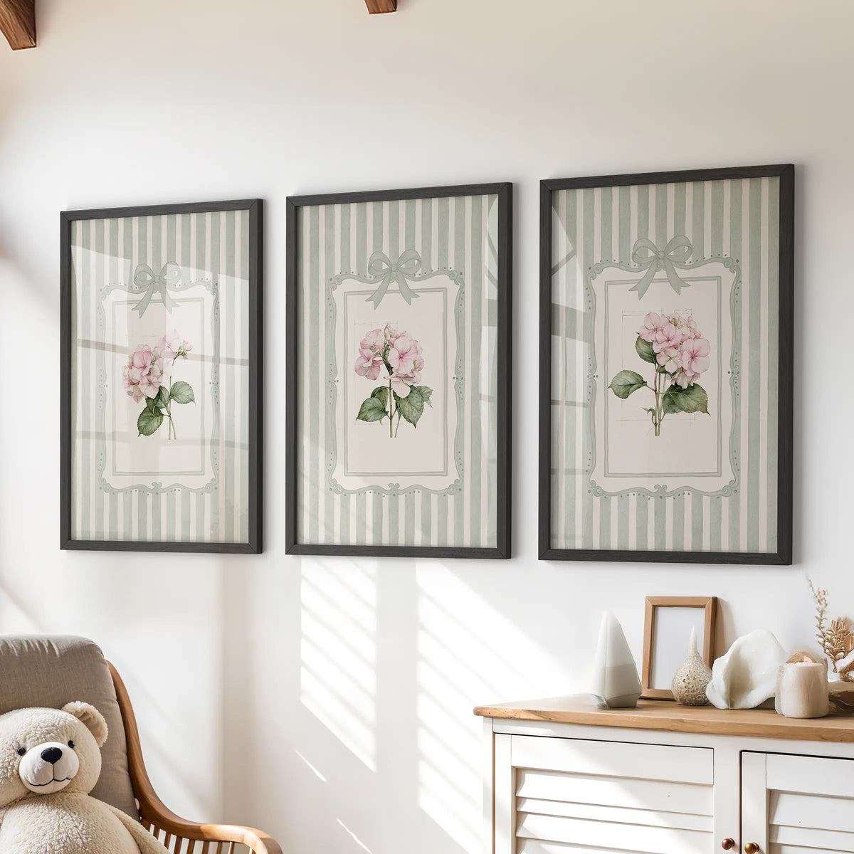 Three-print wall art set featuring pink hydrangea blooms in black frames above a dresser in a kids' room.
