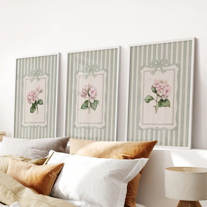Set of three wall prints featuring vintage botanical florals in white frames above a bedroom headboard.