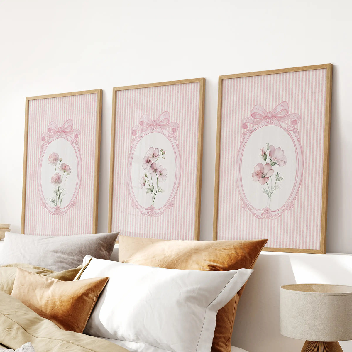 Shabby chic flowers in a three-piece wall art set, displayed in oak frames above the headboard in a bedroom.