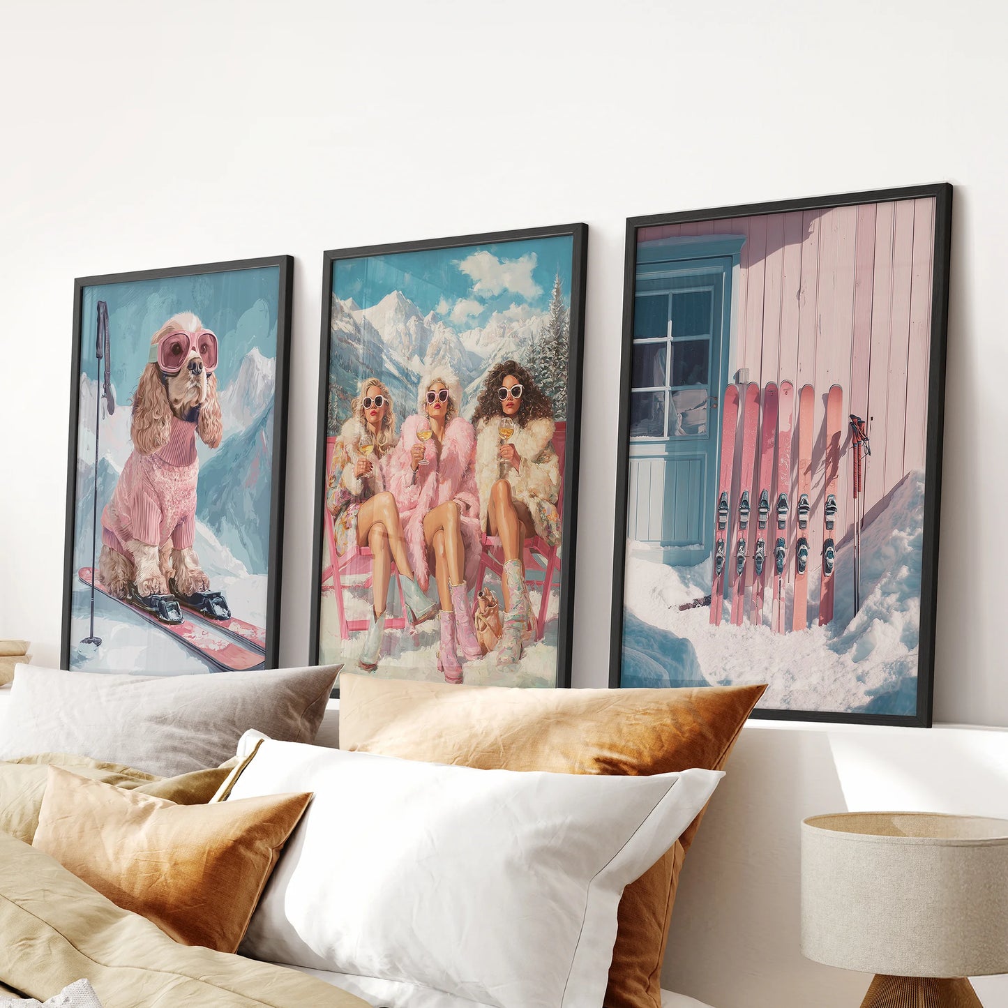 Three black-framed ski lodge art prints create warm alpine charm in a bedroom, perfectly arranged above the headboard for a preppy winter look.